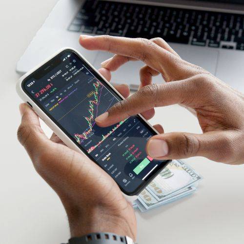 Kanak Capital Markets and online trading app interface showing live charts and technical analysis on mobile.